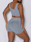 Close up back right side profile shot of our model wearing the Figure Scrunch Shorts in Carbon color