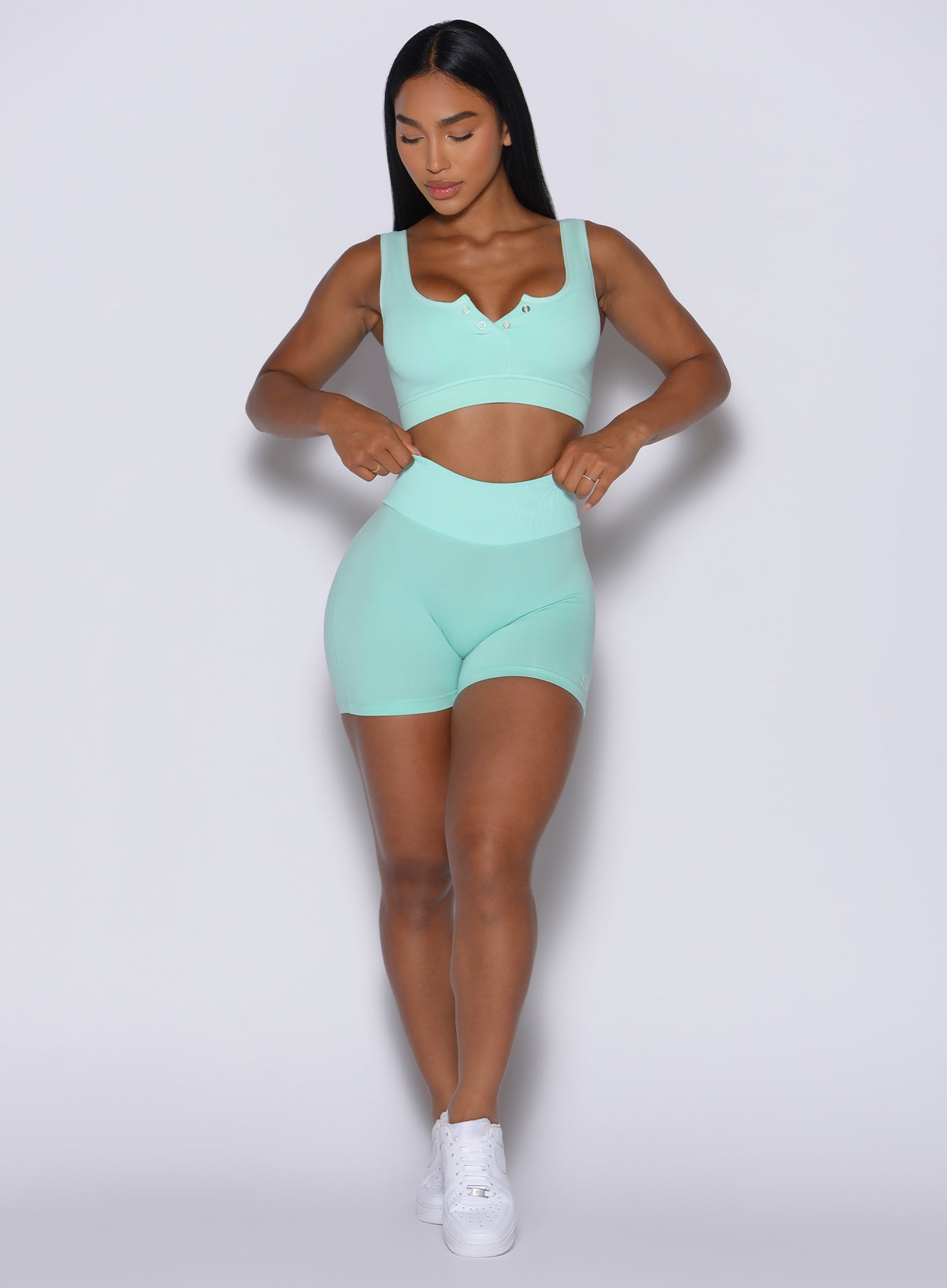 Front profile view of our model wearing the Figure Scrunch Shorts in Spring Mint color