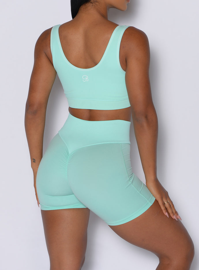 Close up back profile shot of our model wearing the Figure Scrunch Shorts in Spring Mint color