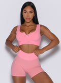 front profile view of a model wearing our Snap Seamless Bra and the matching shorts in Peach Burst color