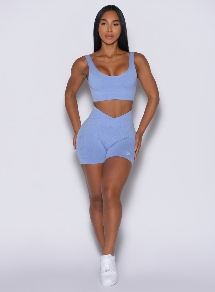 Model facing forward wearing our Contour Seamless Shorts and the matching Seamless Scoop Bra in Sky color