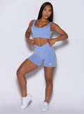 front profile view of a model posing in our Contour Seamless Shorts and the matching Seamless Scoop Bra in Sky color