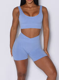 front profile view of a model wearing our Contour Seamless Shorts and the matching Seamless Scoop Bra in Sky color