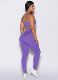 Right side profile view of a model wearing our shape leggings in royal purple color along with the matching bra