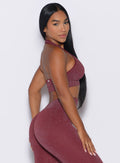 right side profile view of a model looking over her shoulder wearing the Shimmer Backless Bra in Ruby star color