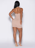 back profile view of a model wearing the Shimmer Seamless Dress in Champagne star color