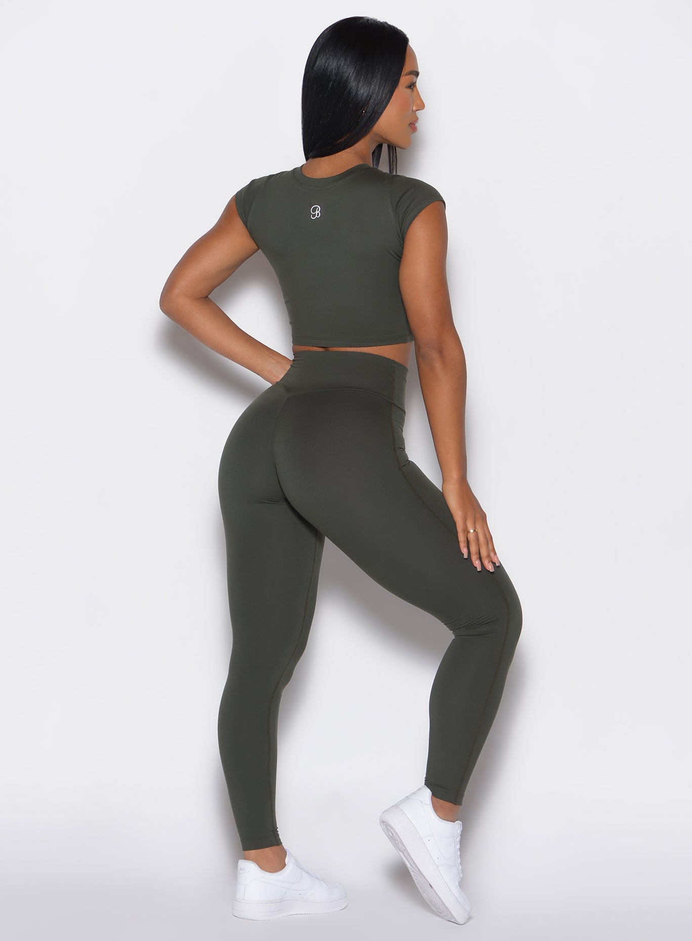 back profile view of a model in our Smooth Leggings and the matching Tee in Deep Ivy color