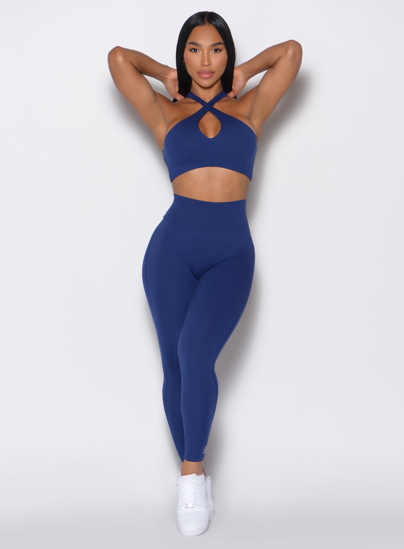 Model facing forward wearing our Smooth Leggings and the matching bra in Royal Indigo color