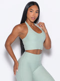 front right side profile view of our model wearing the Lift Halter Bra in soft aloe color