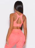 Back profile view of our model wearing the Square Neck Bra in coral reef color along with the matching leggings