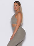 left side profile picture of a model wearing our viral tank bra in nori color along with the matching leggings