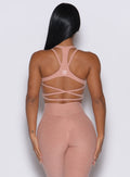 back profile picture of a model wearing our viral tank bra in nude sand color along with the matching leggings