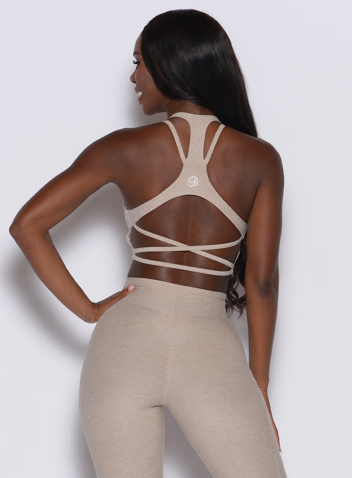 back profile picture of a model wearing our viral tank bra in taupe color along with the matching leggings