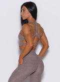 left side profile picture of a model wearing our viral tank bra in london fog color along with the matching leggings