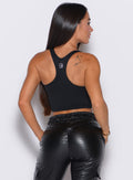 back profile view of our model facing to the right side wearing the Sugar Tank Bra in Black color