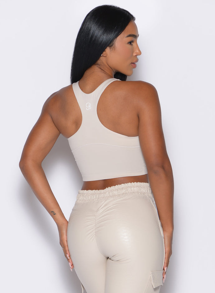 back profile view of our model facing to the right side wearing the Sugar Tank Bra in champagne color