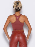 back profile view of our model wearing the Sugar Tank Bra in brick red color