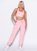 front profile view of our model with one hand inside the pocket of the Sweat Joggers in Tickled Pink color