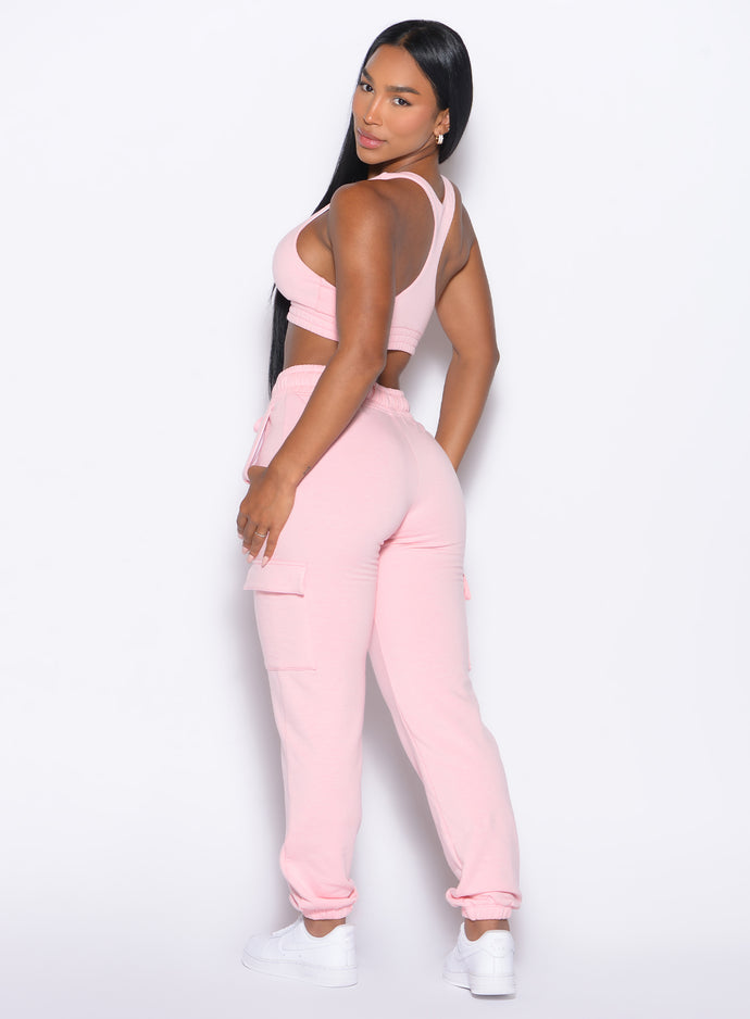 back left side profile view of our model looking over her shoulder wearing the Sweat Joggers in Tickled Pink color