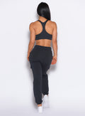 back profile view of our model wearing the Sweat Joggers in Vintage Black color paired with the matching bra