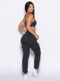 right side profile view of our model looking over her shoulder wearing the Sweat Joggers in Vintage Black color