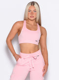 front profile view of our model with one hand inside the pocket of the joggers wearing the Sweat Lounge Bra in Tickled Pink color