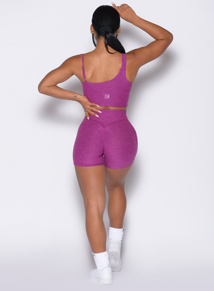 Back side close up view of model wearing the Tiny Waist Shorts and the matching Asymmetrical Slit Bra in Bright Plum color