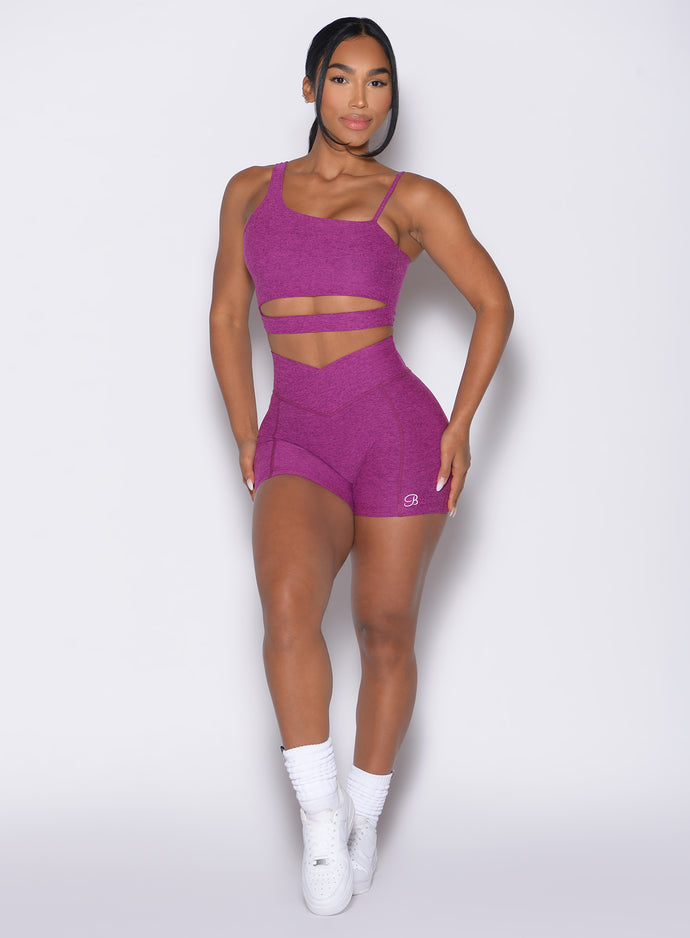 front profile view of a model wearing our Tiny Waist Shorts and the matching Asymmetrical Slit Bra in Bright Plum color