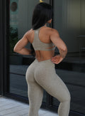 Back right side profile view of a model in outdoors wearing the V Butt Lift Leggings in Toasted Sugar color