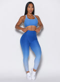 front profile picture  of a model wearing our toggle leggings in Ombre Blue Crush color along with the matching sports bra