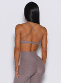 back profile picture of a model wearing our Tiny Twist bra in London Fog color along with the matching leggings.