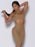 Front  profile picture of a model in our two way sports bra in caramel color and a matching leggings