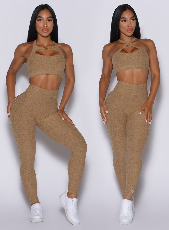 two front profile pictures of a model wearing our pocket pop leggings in caramel color and a two way bra 