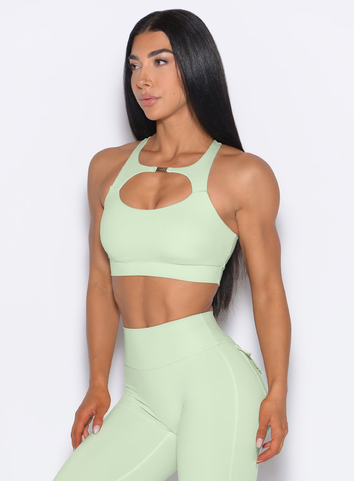 front profile picture of a model in our Two Way Bra in Cool Matcha color and a matching leggings 