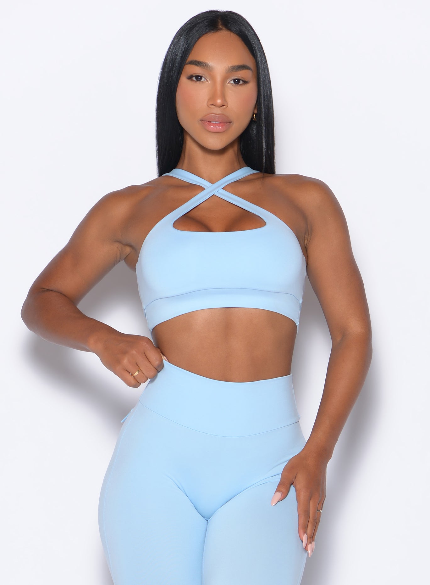 front profile picture of a model in our Two Way Bra in Glacial Blue color and a matching leggings 
