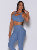 picture of a model facing forward wearing our two way bra in sky blue color and a matching leggings 