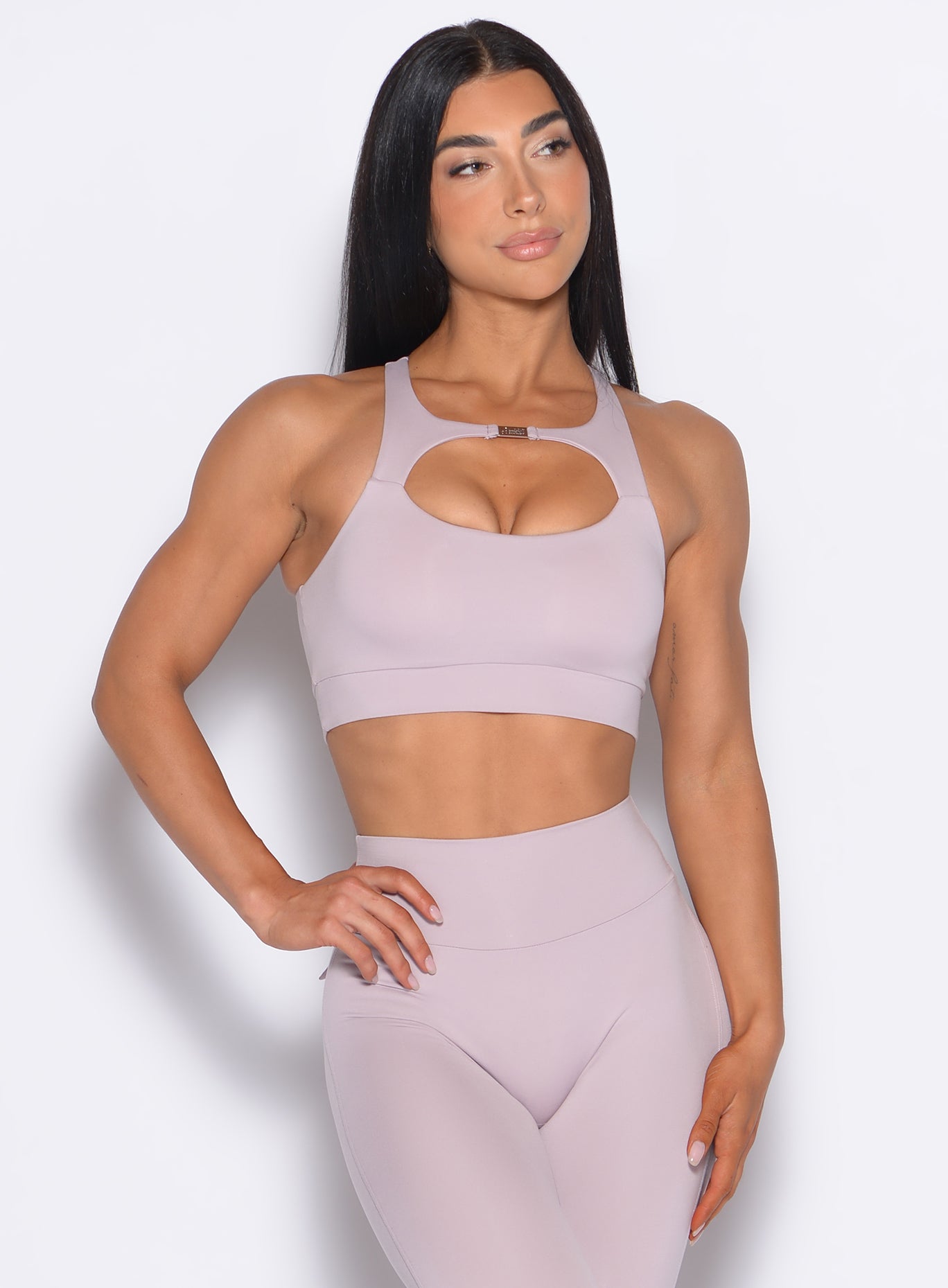 Model facing forward wearing our Two Way Bra in Violet Ice color and a matching leggings 
