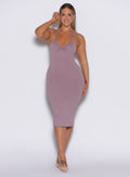 front profile view of a model wearing our unforgettable dress in light mauve color