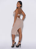 left side profile view of a model facing to her left wearing our unforgettable dress in camel color