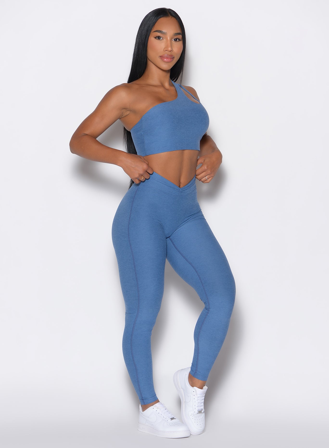 front profile view of a model wearing our V Active Leggings and the matching Top in Chambray color