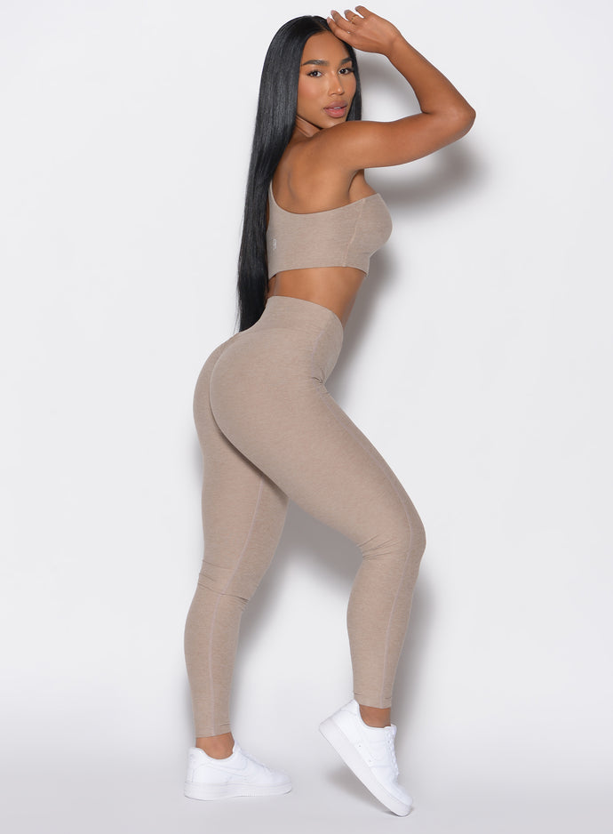 Right side view of a model facing to her right wearing our V Active Leggings and the matching Top in Desert Taupe color