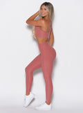 left side view of a model in our V Active Leggings and the matching Top in Sedona Clay color