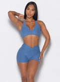 Model facing forward wearing our V Active Shorts and the matching bra in Chambray color