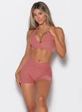 front profile view of a model wearing our V Active Shorts and the matching bra in Sedona Clay color