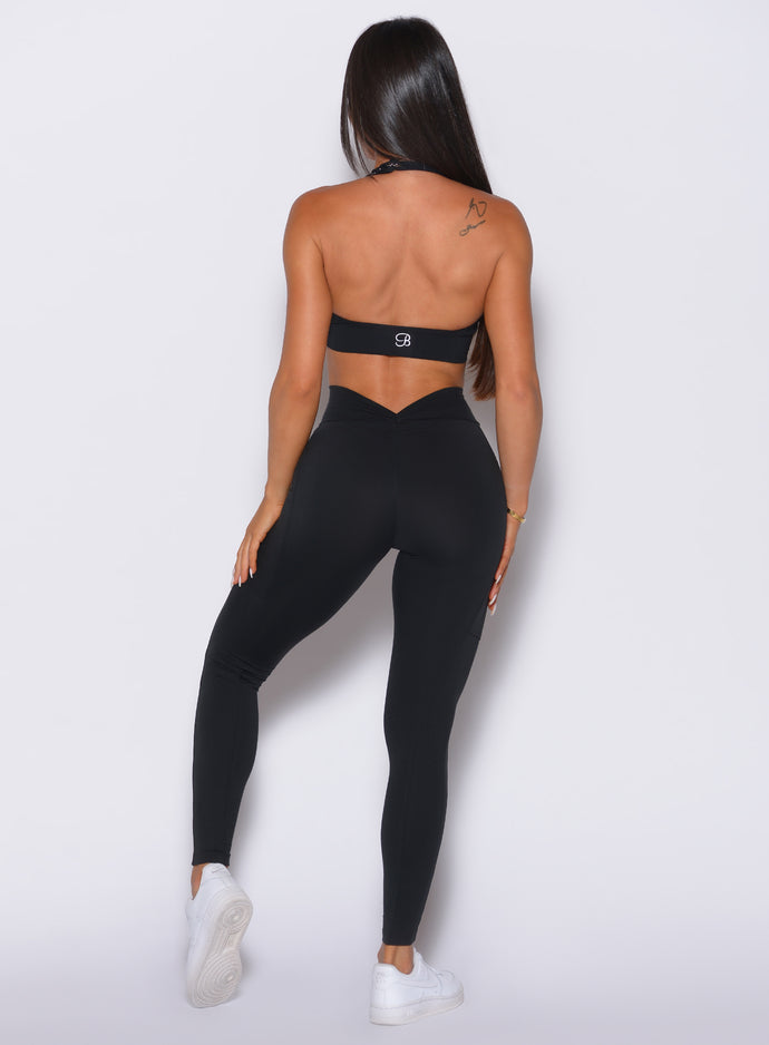 back shot of model in all black wearing our v back leggings