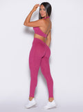 side shot of model wearing our pink v back leggings set