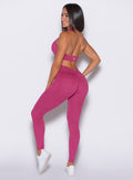 side profile of model smiling wearing the v back leggings