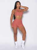 front right side profile view of a model wearing the V Back Shorts in Georgia Peach color