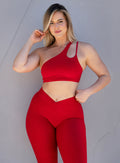 Zoomed in front profile picture of a model wearing our V active leggings in scarlet red color along with the matching top 