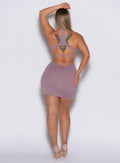 back profile view of a model in our viral dress in light mauve color